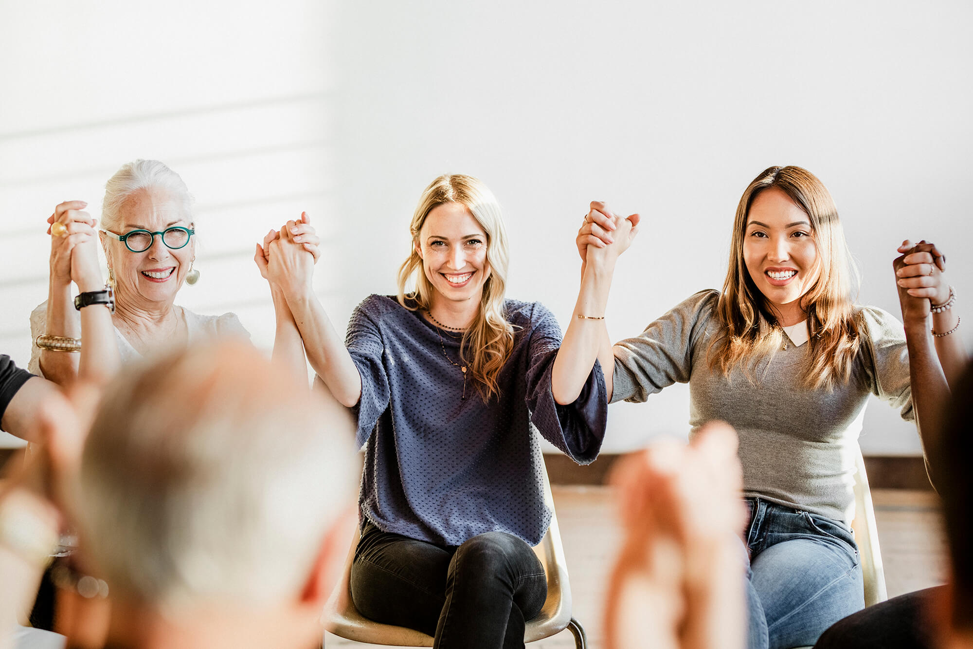 group-of-diverse-people-holding-hands-up-in-the-ai-MAJ7XT5-1.jpg